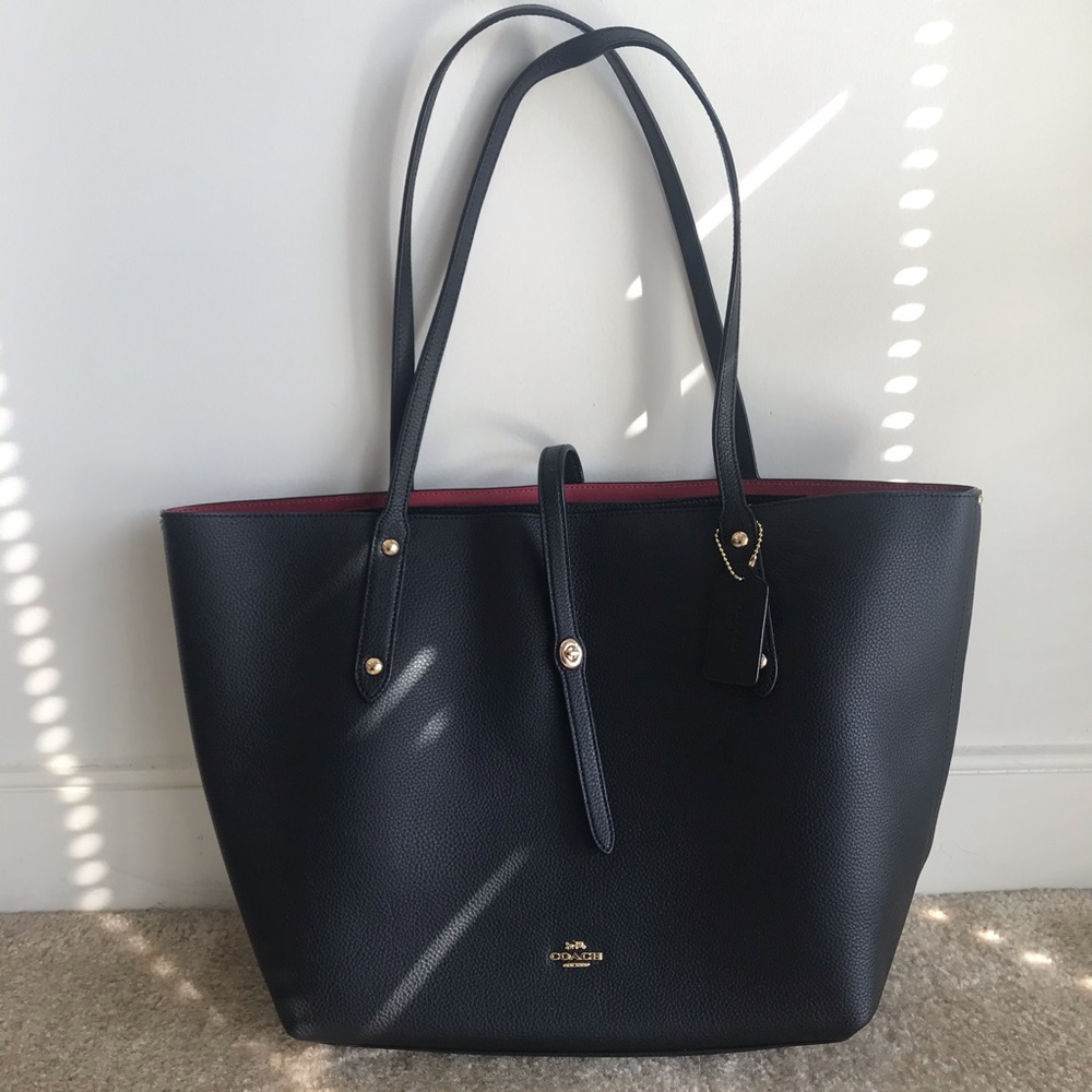 Black Coach tote bag with garment bag.